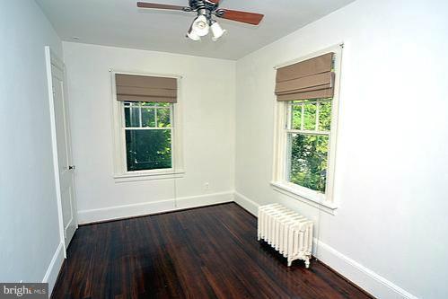 2311 Forest Glen Road Silver Spring, MD 20910 - Photo 24 of 28 an empty room with wooden floor fan and windows
