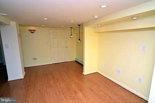2311 Forest Glen Road Silver Spring, MD 20910 - Photo 9 of 28 a view of an empty room with wooden floor and a window