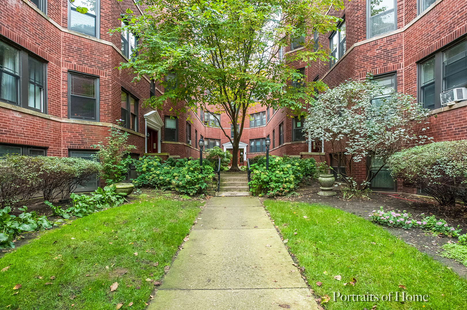530 Sheridan Road, Unit 2A Evanston, IL 60202 - Photo 1 of 11 a front view of a house with a garden