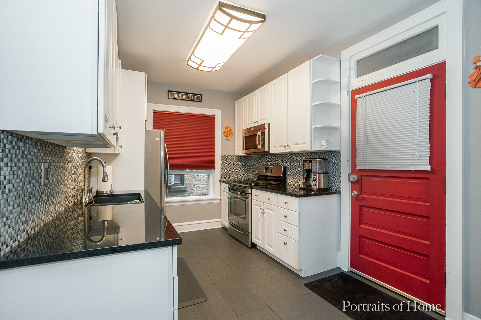 530 Sheridan Road, Unit 2A Evanston, IL 60202 - Photo 5 of 11 a kitchen with granite countertop stainless steel appliances a sink stove refrigerator and cabinets