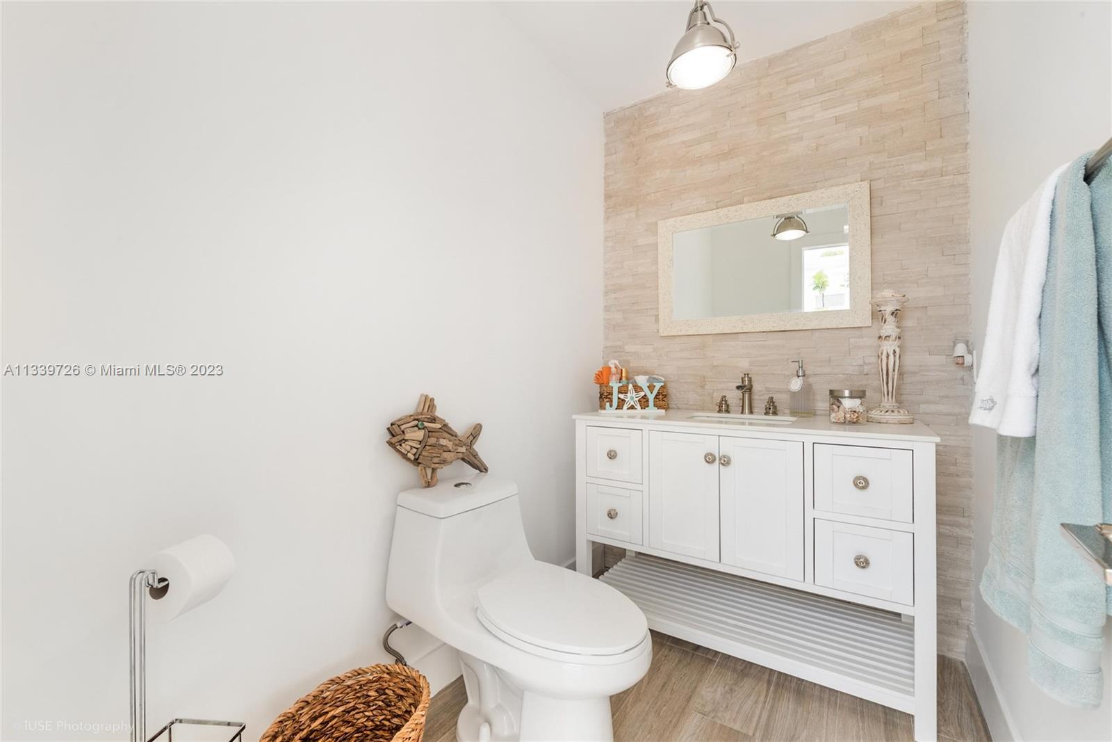 8528 Southwest 121st Street Miami, FL 33156 - Photo 12 of 26 a bathroom with a granite countertop toilet sink mirror and vanity