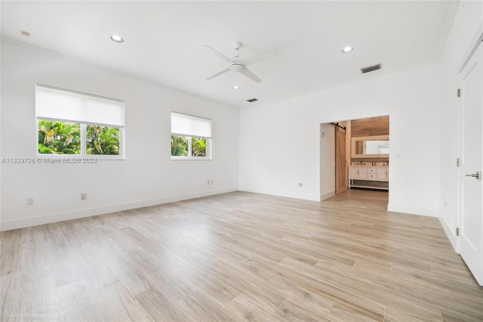 8528 Southwest 121st Street Miami, FL 33156 - Photo 13 of 26 a view of an empty room with wooden floor and a window