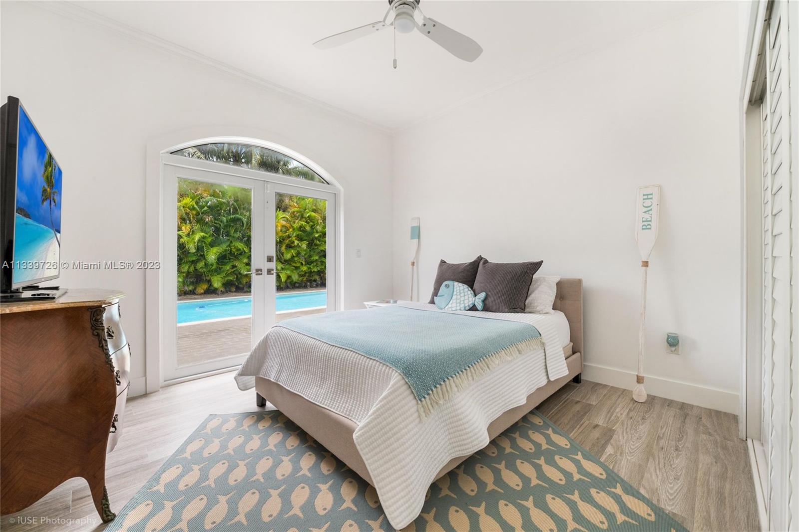8528 Southwest 121st Street Miami, FL 33156 - Photo 19 of 26 a bedroom with a bed and a chandelier