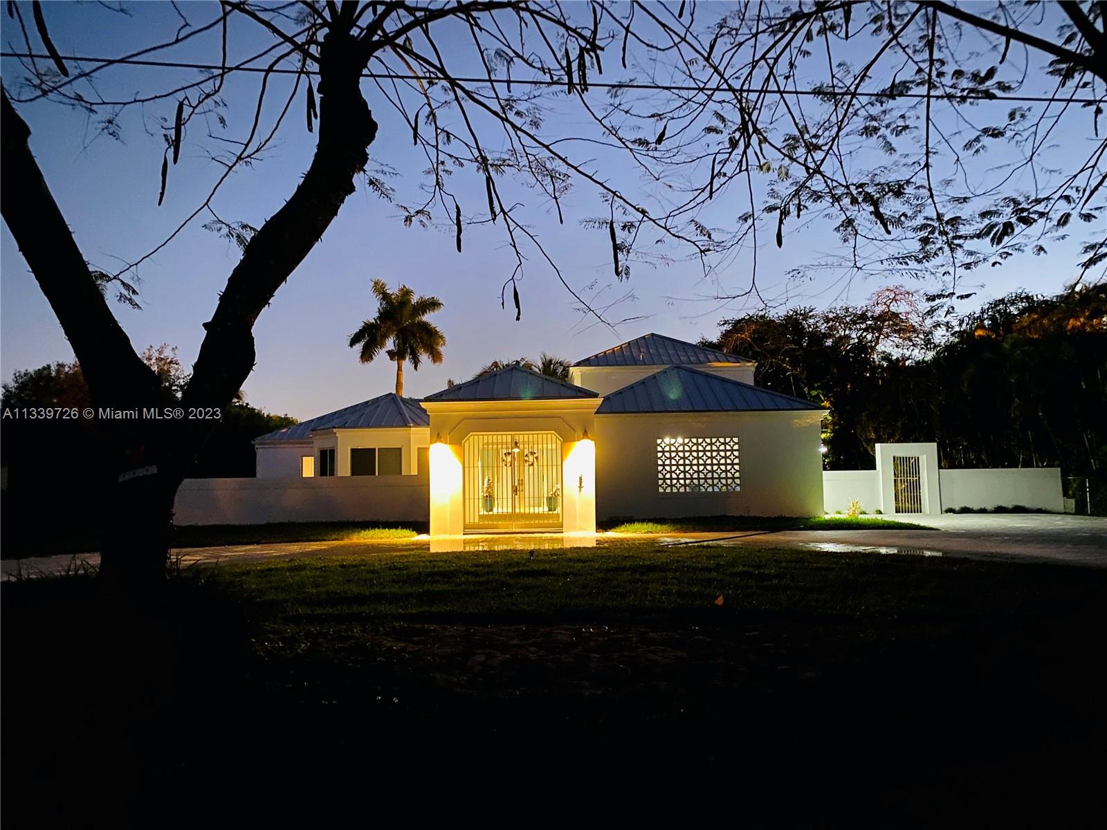 8528 Southwest 121st Street Miami, FL 33156 - Photo 2 of 26 a front view of a house with a yard