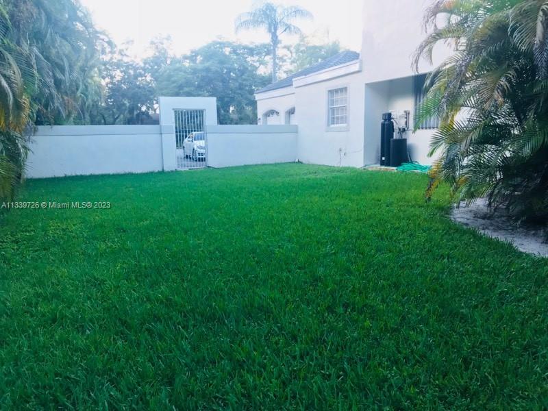 8528 Southwest 121st Street Miami, FL 33156 - Photo 26 of 26 a front view of a house with a yard and garage