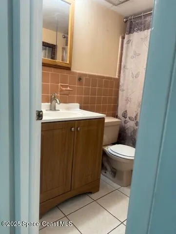 a white toilet sitting next to a bathroom sink