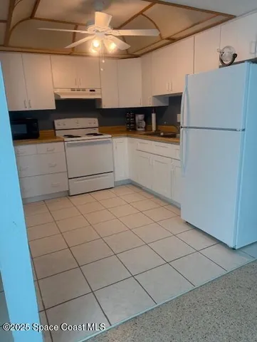 a kitchen with stainless steel appliances a refrigerator sink and cabinets
