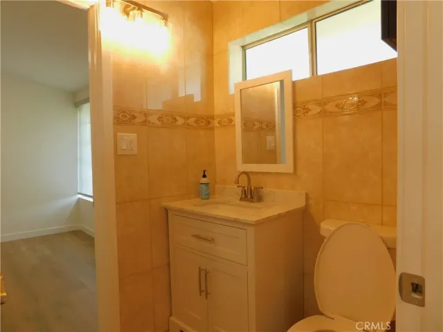a bathroom with a sink mirror and a shower