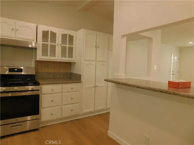 a kitchen with stainless steel appliances granite countertop a stove and a refrigerator