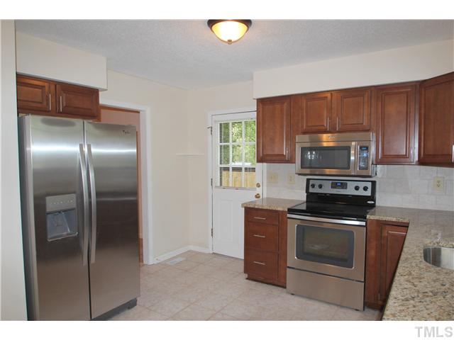 817 Wyldewood Road Durham, NC 27704 - Photo 3 of 14 a kitchen with cabinets stainless steel appliances and a counter space