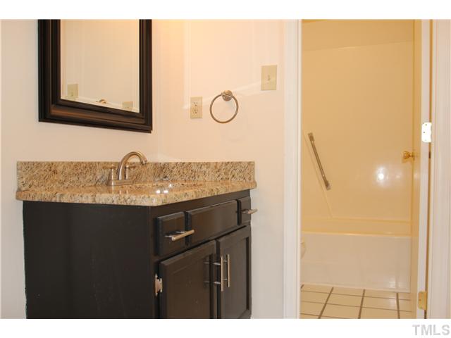 817 Wyldewood Road Durham, NC 27704 - Photo 8 of 14 a bathroom with a sink and a mirror