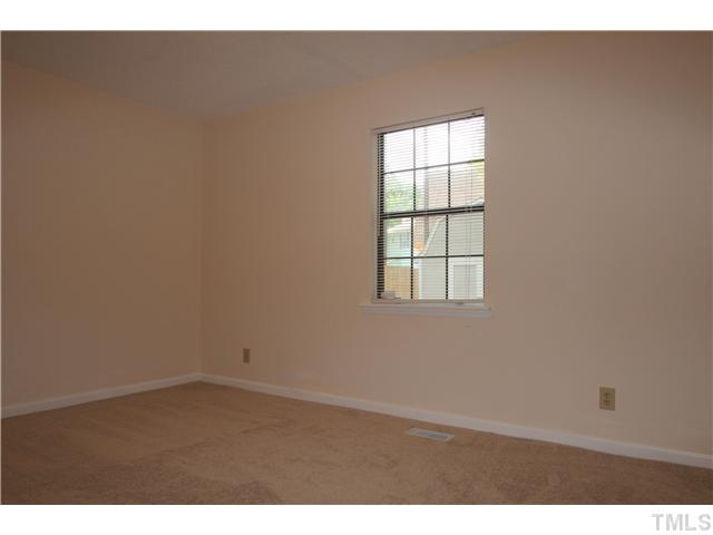 817 Wyldewood Road Durham, NC 27704 - Photo 9 of 14 an empty room with wooden floor and windows
