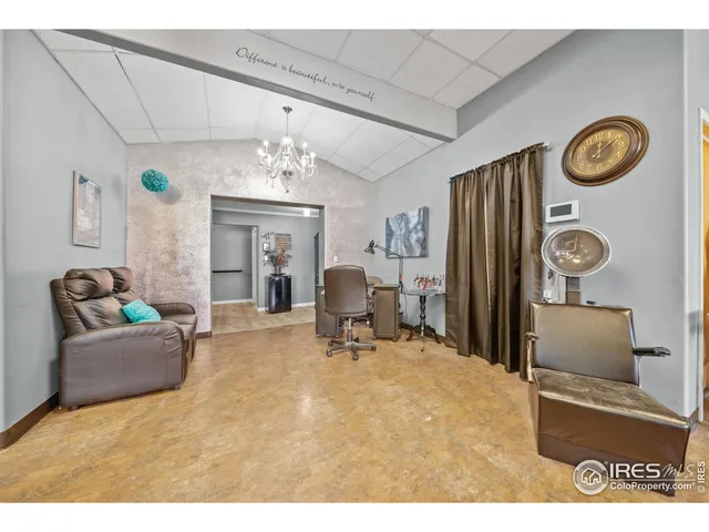 a living room with furniture and a clock