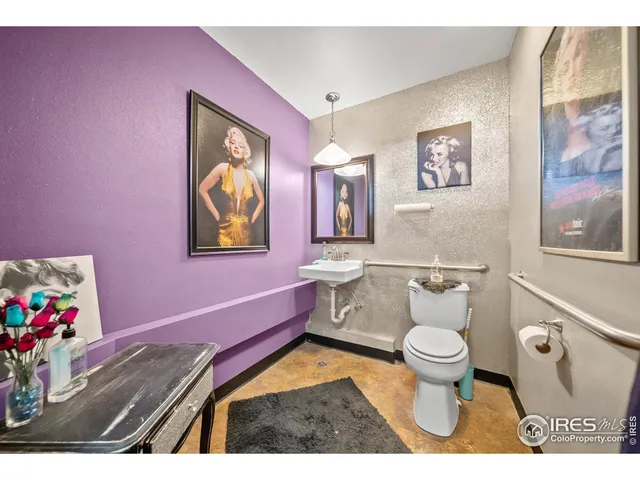a bathroom with a sink mirror vanity and toilet