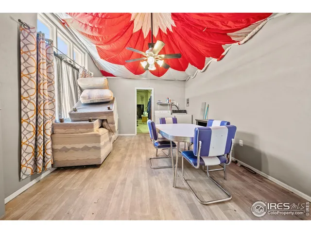 a dining room with furniture and wooden floor