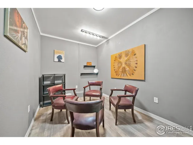 a dining room with furniture and a flat screen tv