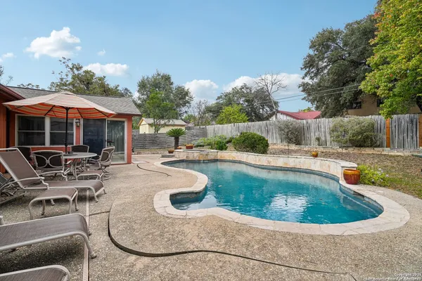 a view of a swimming pool with lounge chair