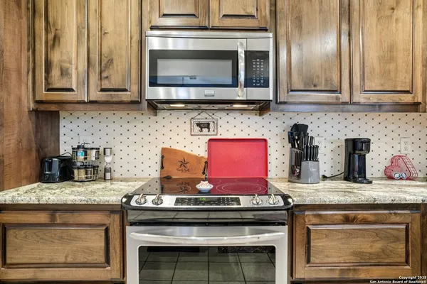a stove top oven sitting inside of a kitchen