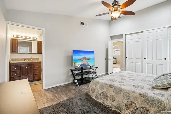 a bedroom with a bed and a chandelier