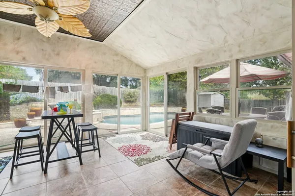 a living room with furniture and a floor to ceiling window