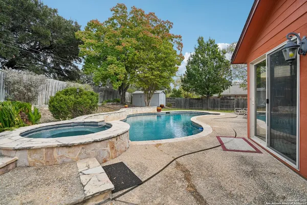 a view of a swimming pool with a patio