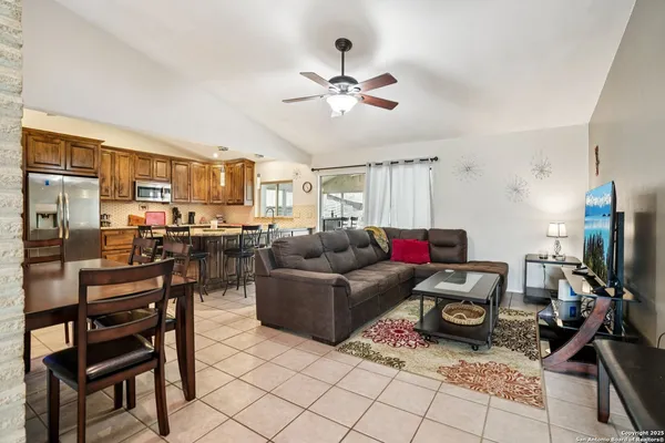 a living room with furniture and kitchen view
