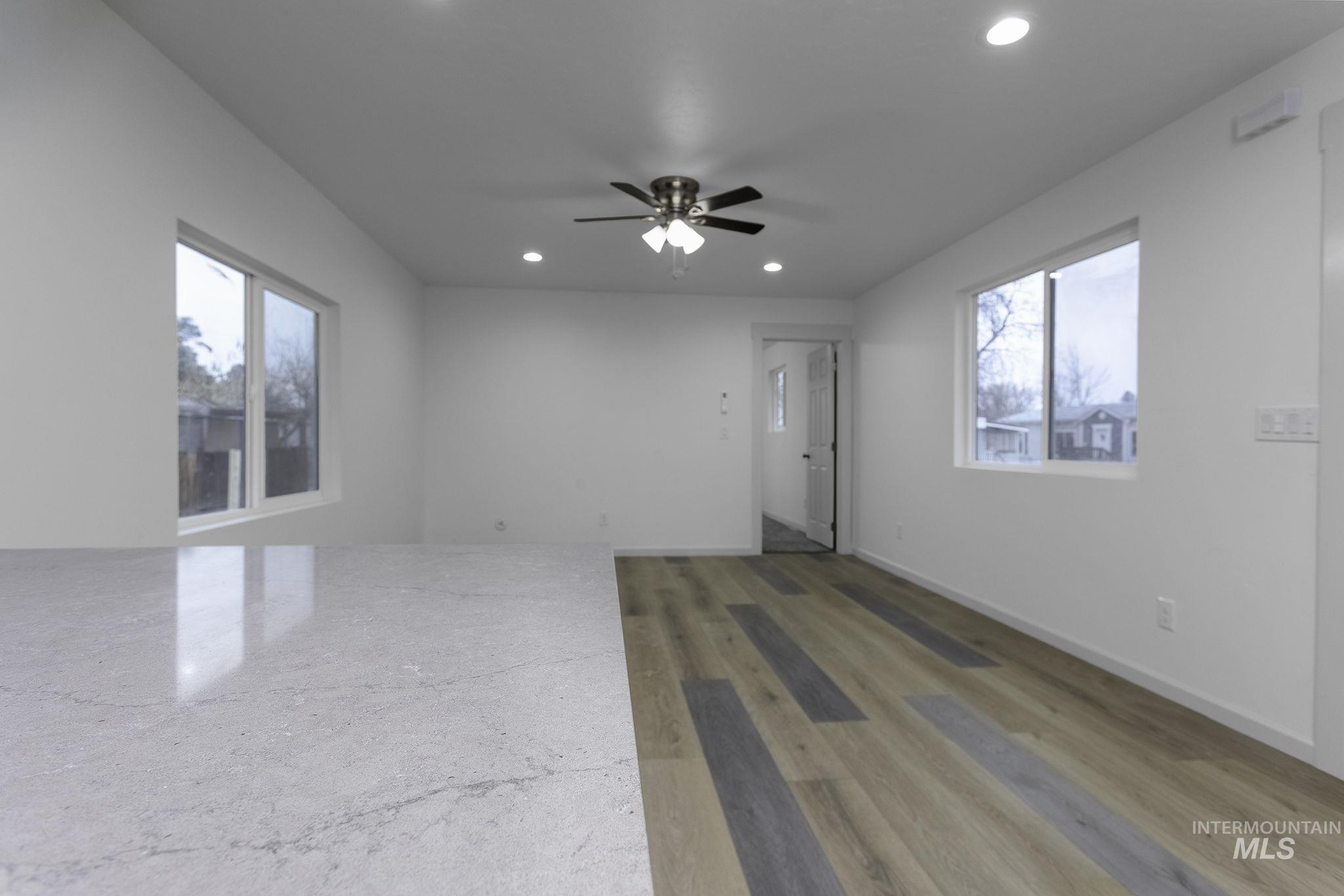 450 Greenleaf Street Boise, ID 83713 - Photo 5 of 17 Unfurnished room with a ceiling fan, light wood finished floors, recessed lighting, and plenty of natural light