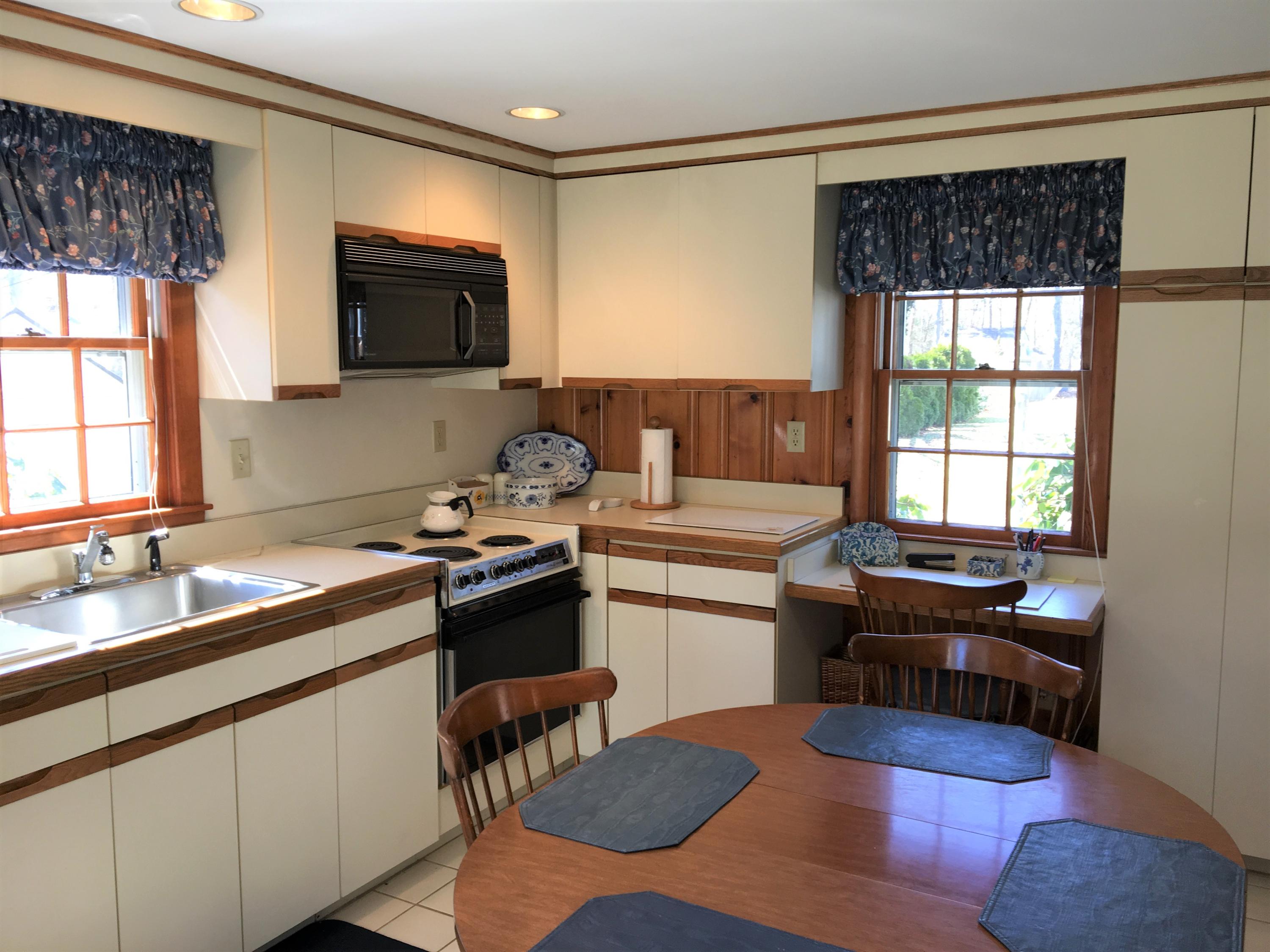 84 Uncle Edwards Road Mashpee, MA 02649 - Photo 11 of 22 a kitchen with a sink stove and microwave