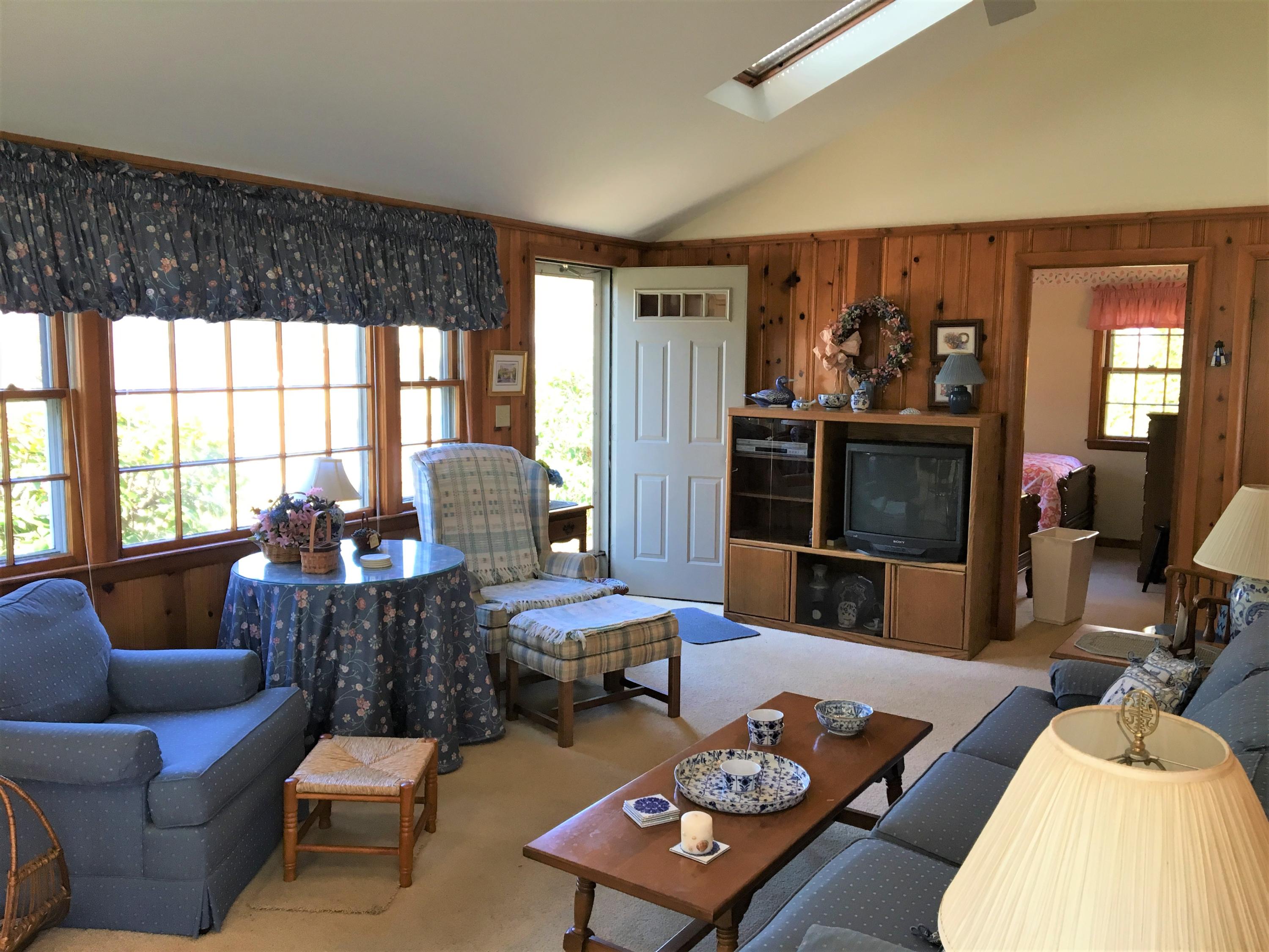 84 Uncle Edwards Road Mashpee, MA 02649 - Photo 12 of 22 a living room with furniture a flat screen tv and a large window