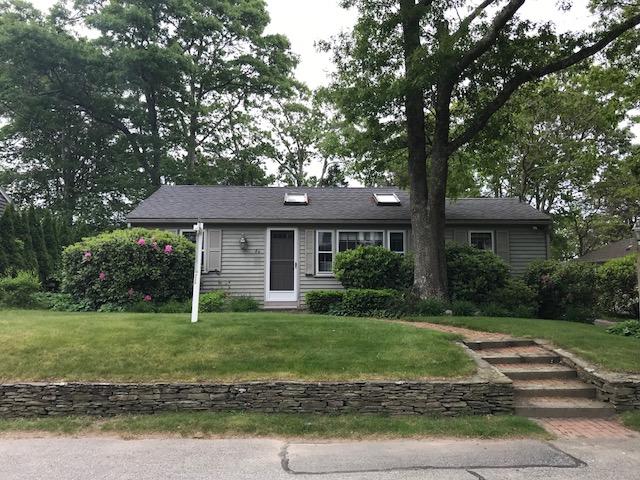84 Uncle Edwards Road Mashpee, MA 02649 - Photo 2 of 22 a front view of a house with a yard