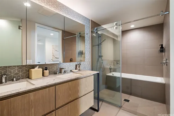 a bathroom with a granite countertop sink mirror and double