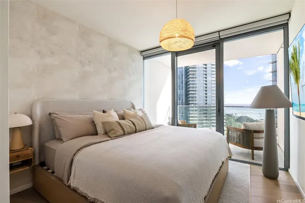 a bedroom with a bed and a chandelier