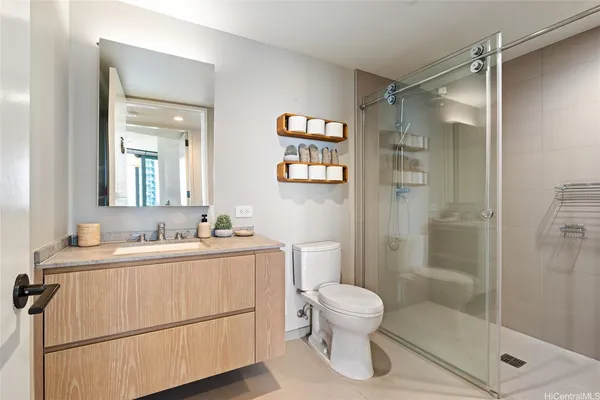 a bathroom with a sink toilet and shower