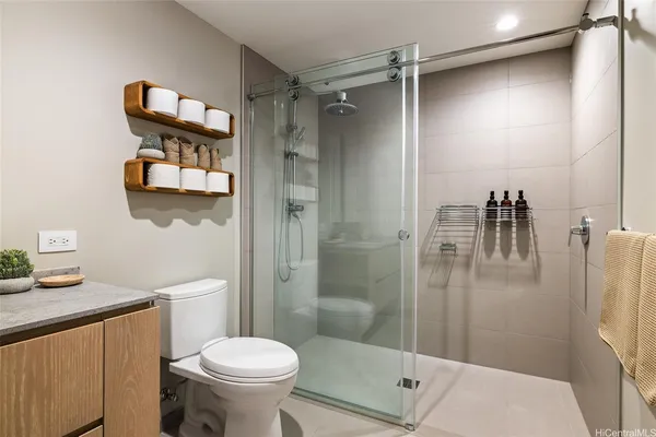 a bathroom with a toilet a sink and shower