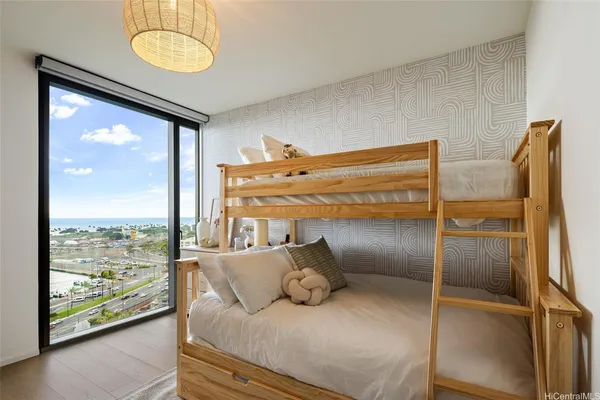 a bedroom with a bed and a large window