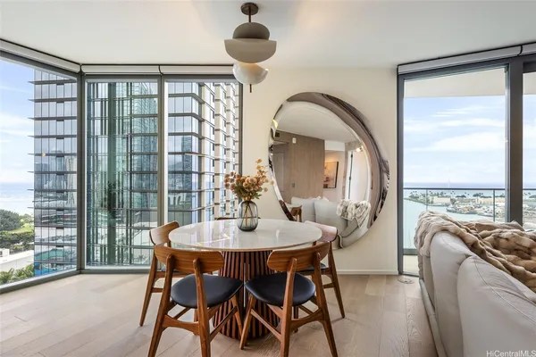 a view of a dining room with furniture large windows and wooden floor