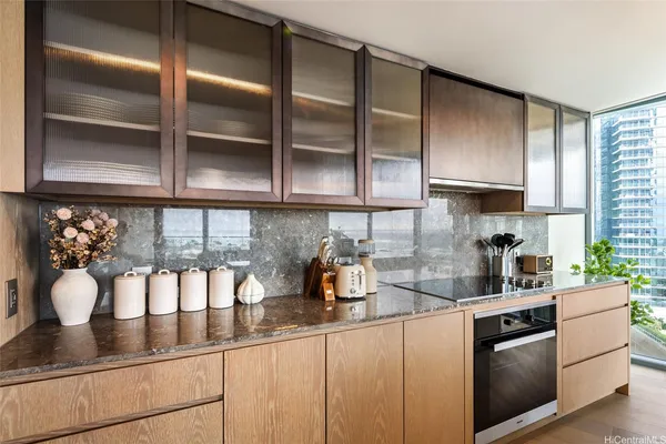 a kitchen with granite countertop stainless steel appliances a sink and cabinets