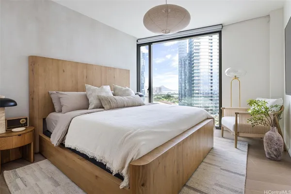 a bedroom with a large bed and a large window