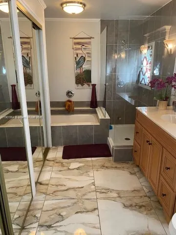 a bathroom with a tub sink and mirror