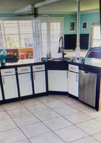 a kitchen with stainless steel appliances a sink and a counter