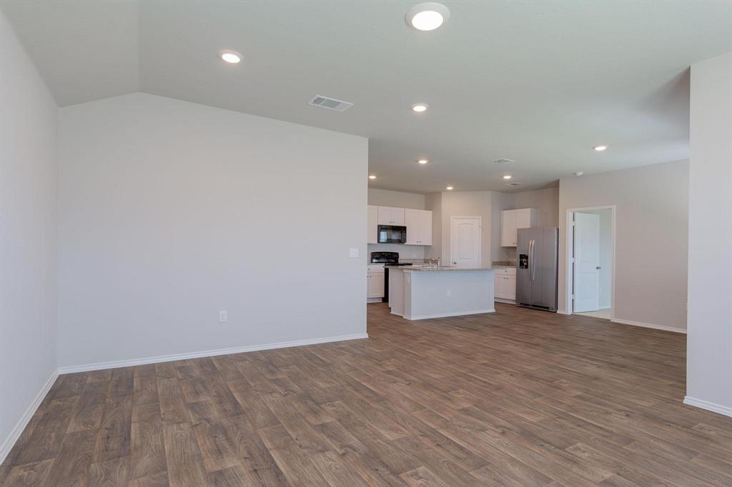 6009 Ronee Leah Drive Austin, TX 78724 - Photo 3 of 16 An open-concept living area flows seamlessly into a well-appointed kitchen, ideal for modern living.