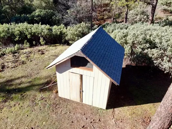 a view of a backyard of a house with a yard