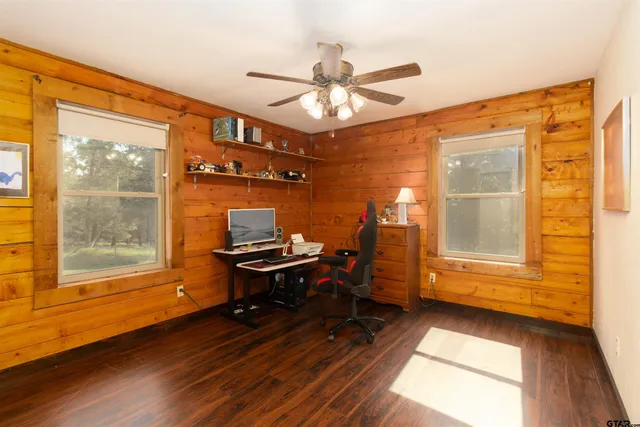 a view of workspace with wooden floor and ceiling fan