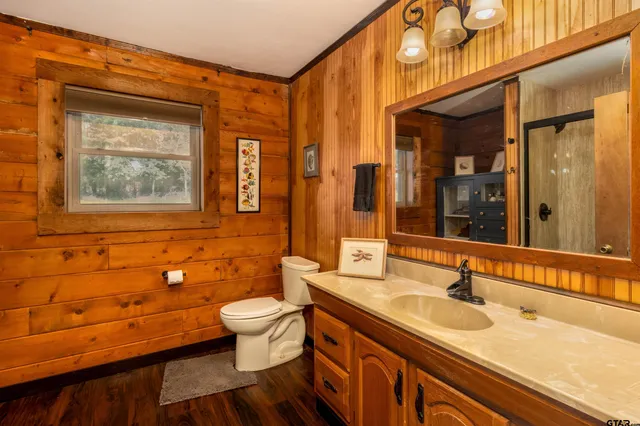 a bathroom with a shower and a glass door