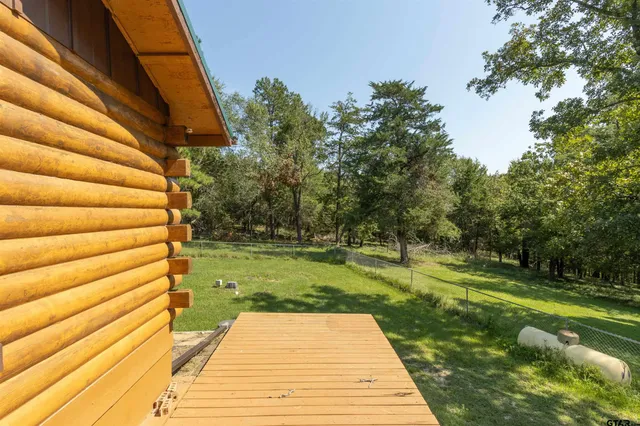 a front view of house with yard and trees