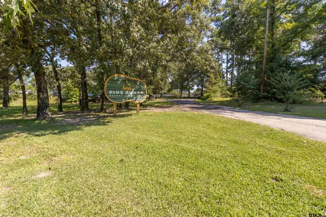 a view of a street with a cars parked