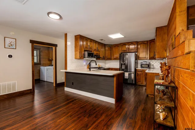a kitchen with stainless steel appliances granite countertop a sink and a stove