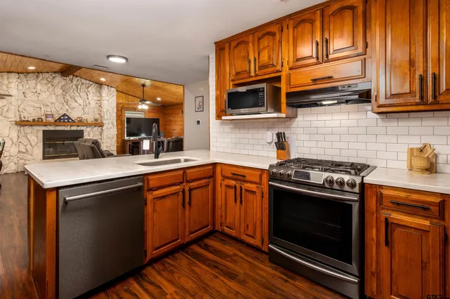 a living room with furniture a flat screen tv and a fireplace