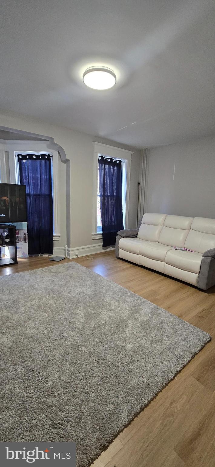 944 Walnut Street Allentown, PA 18102 - Photo 1 of 7 a bedroom with a bed and a couch