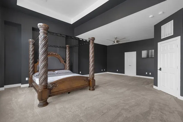 a bedroom with bed and a large window